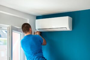 man working on mini split ac unit